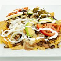 Nachos · Topped with beans, cheese and your choice of meat.