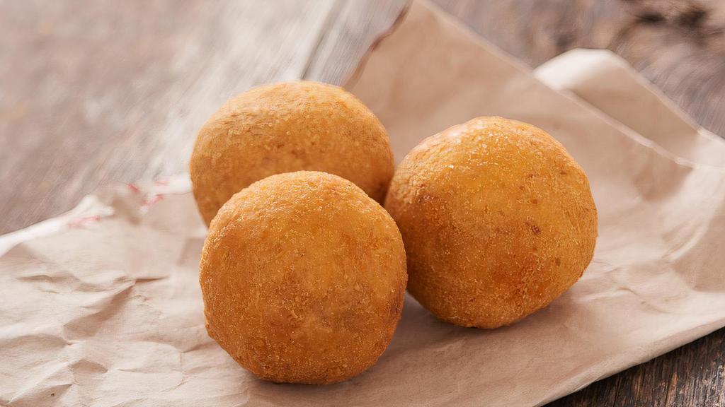 Arancini · Crispy deep fried balls of rice made up of mozzarella cheese filling and a crunchy breadcrumb coating.