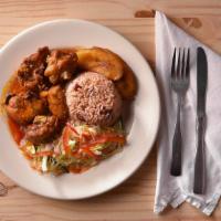 Brown Stew Chicken · Served with boiled green banana, boiled dumplings, and fried ripe plantains.
