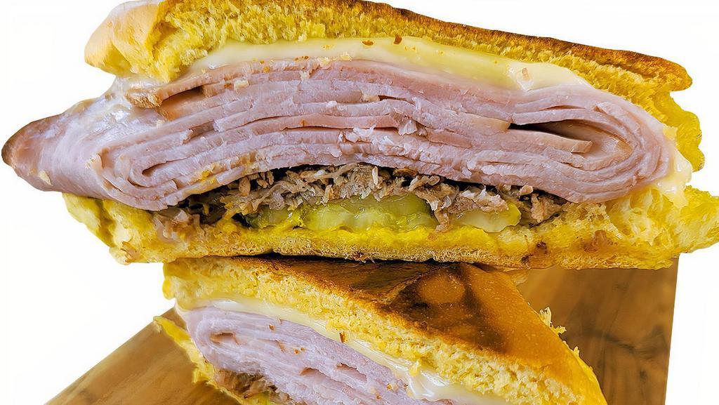 Midnight Sandwich · Roasted Pork, Smoked Ham, Swiss Cheese, Pickles, and Mustard On a Sweet Cuban Roll.