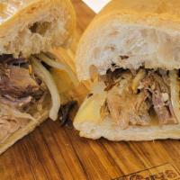 Pulled Pork Sandwich · Slow Roasted Pork, Grilled Onions, and Mojo.