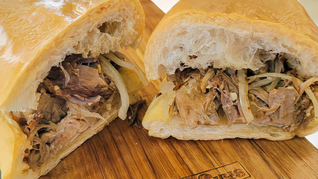 Pulled Pork Sandwich · Slow Roasted Pork, Grilled Onions, and Mojo.