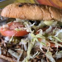 Torta Barbacoa · Onions, tomatoes, jalapeño peppers, lettuce, refried beans.