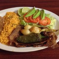 Carne Asada · Tow pieces of steak served with rice beans, salad and corn tortillas.