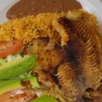 Filete A La Plancha · Two fish filets with rice beans and rice