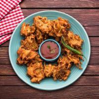 Onion Fritters · A medley of onions dipped in chickpea & rice flour batter and then deep fried.