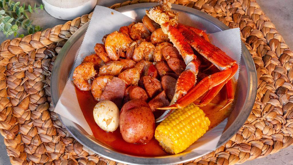 Famous Low Country Boil · half pound snow crab legs, half pound shrimp (no head), half pound all-meat sausage, one boiled egg, one corn, one potato.