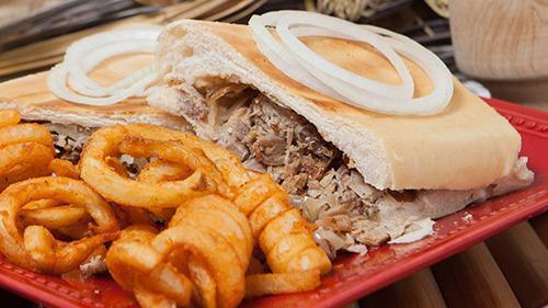 Pan Con Lechon · Mojo grilled pork, grilled onions, Cuban Bread