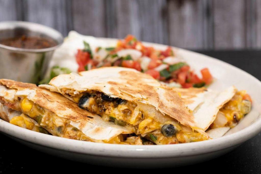 Smoked Chicken Quesadillas · in-house smoked chicken · pepper jack · cheddar · green chiles · roasted corn · black beans · pico de gallo · served with fire roasted salsa & sour cream