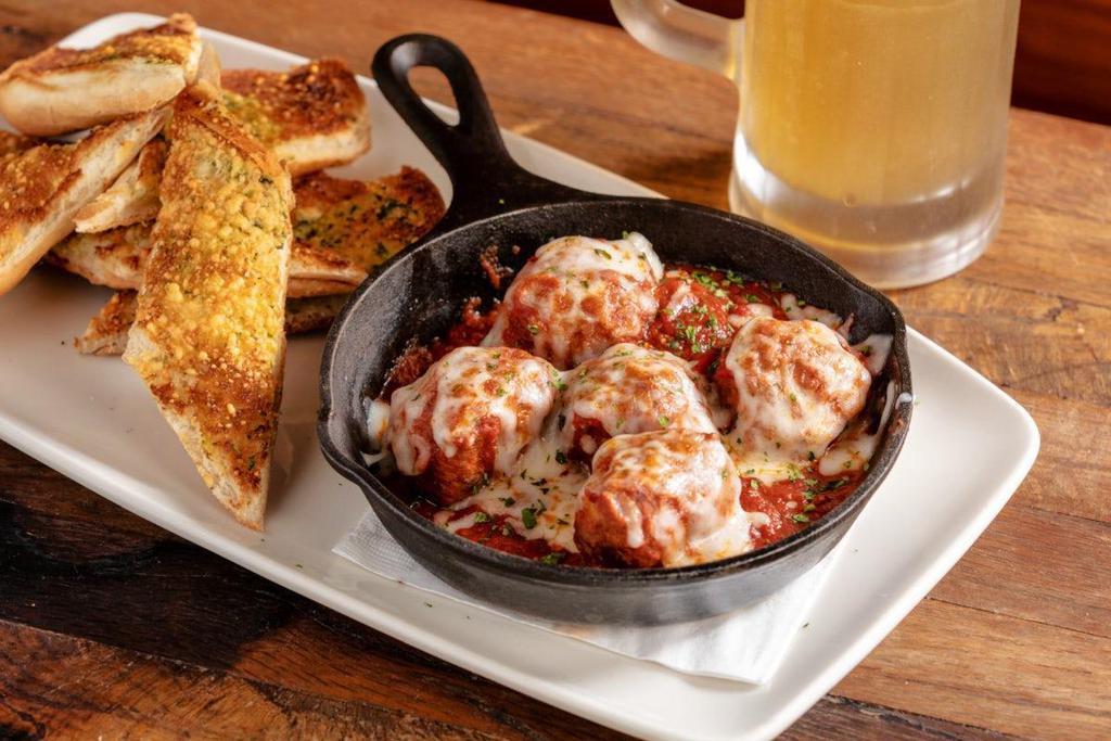 Spicy Meatball Skillet · all-beef house made meatballs · marinara made in-house with San Marzano tomatoes · mozzarella · Parmesan · parsley · toasted garlic bread