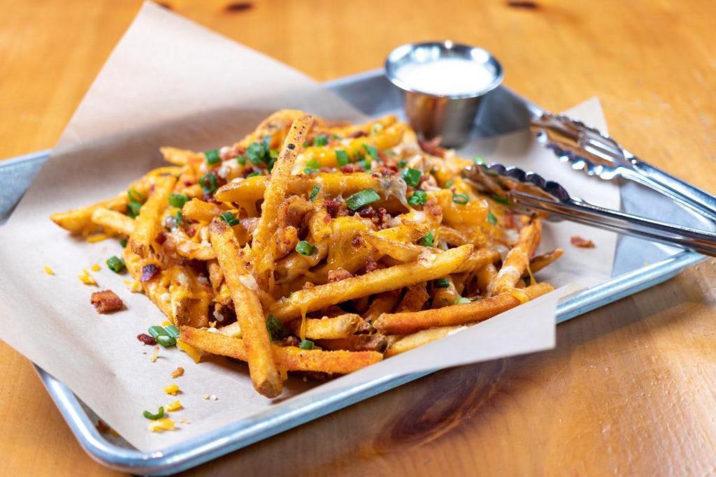 Loaded Fries - Bacon & Cheese · piled high seasoned fries · cheddar · pepper jack · bacon bits · green onions · bacon ranch