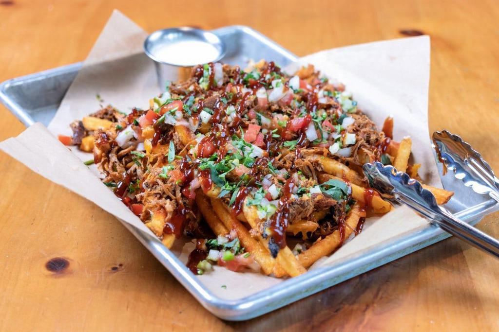 Loaded Fries - Hickory Smoked Pulled Pork · piled high seasoned fries · hickory smoked pulled pork · cheddar · pepper jack · bacon bits · green onions · pico de gallo · cilantro · diced pickles · smoky sweet BBQ drizzle · bacon ranch