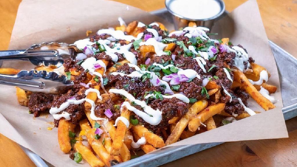 Loaded Fries - Brisket Chili · piled high seasoned fries · brisket chili · cheddar · pepper jack · bacon bits · green onions · red onions · cilantro · sour cream · bacon ranch