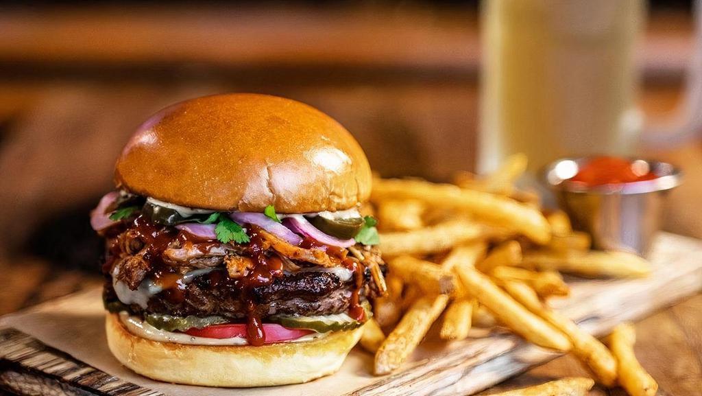 The Smokestack · in-house smoked pulled pork · cheddar · red onions · pickled jalapeños · tomato · pickles · cilantro · smoky sweet BBQ sauce · chipotle mayo · served with seasoned French fries