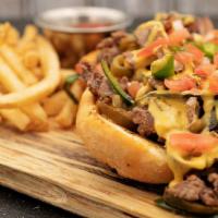 Texas-Style Cheesesteak · thin sliced sirloin · queso · peppers · jalapeños · pico de gallo · toasted hoagie roll · se...