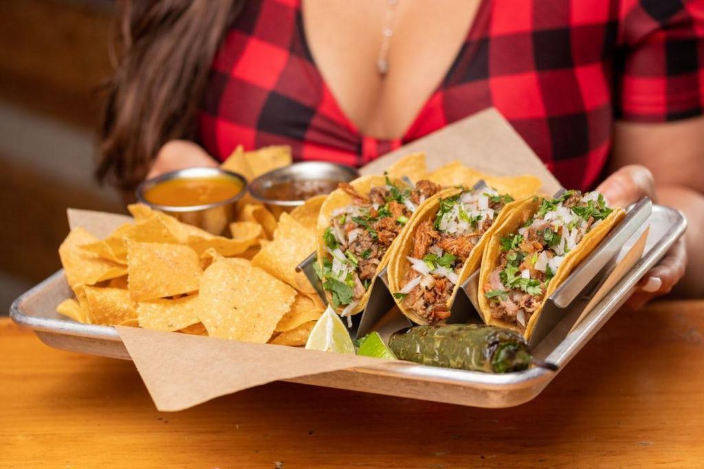 Street Tacos · three doubled up warm corn tortillas · in-house smoked brisket, chicken, pulled pork · pico de gallo · diced onion · cilantro · Served with fire roasted salsa, habanero sauce, tortilla chips, lime wedge, and a grilled jalapeño.