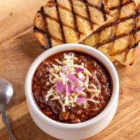 Brisket Chili · topped with pepper jack & red onions · served with a slice of grilled sourdough