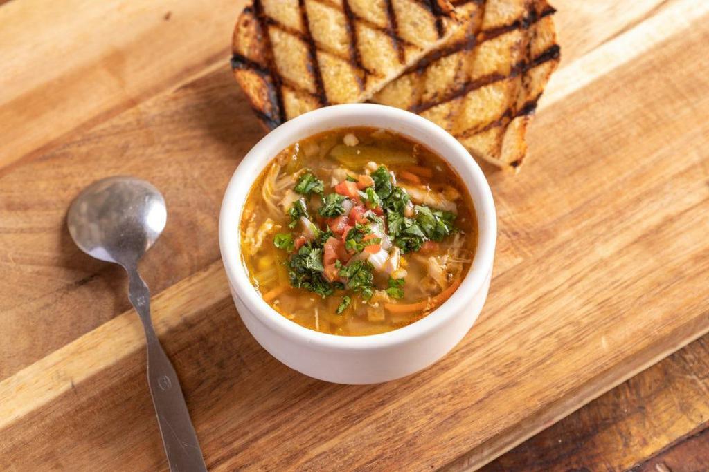 Green Chile Chicken Soup · shredded in-house smoked chicken · New Mexico green chiles · onions · roasted corn · pico de gallo · cilantro · lime · smoked paprika · served with a slice of grilled sourdough