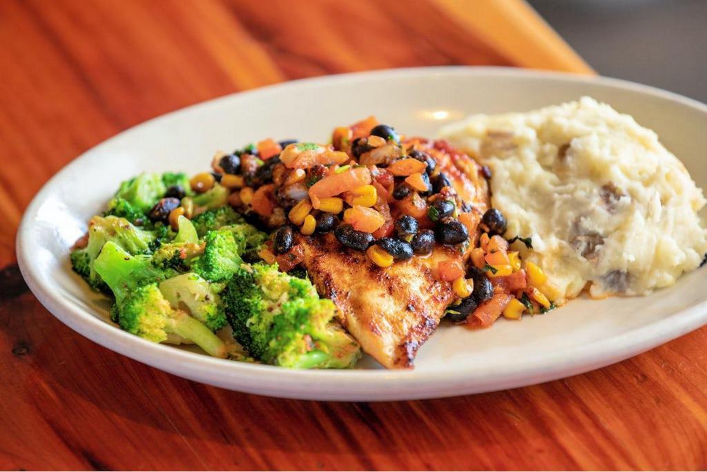 Spicy Chipotle Chicken · blackened chicken breast · topped with southwest pico de gallo · house made garlic mashed potatoes · sautéed broccoli