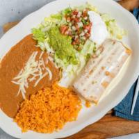 Chimichanga · Deep fried flour tortilla topped with cheese sauce & served with mexican rice , beans , sour...