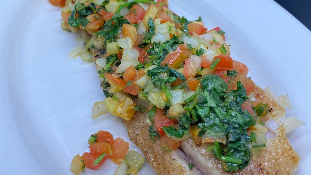 Corvina · Fresh filet of corvina prepared the Caribbean way on a hot grill with lots of onions, fresh tomatoes, and cilantro.