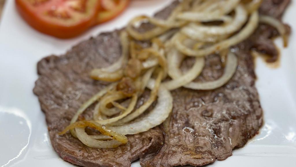 Bistec De Palomilla · Marinated top sirloin grilled and served with 