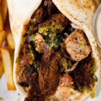 Falafel Wrap · Our signature falafel sandwich comes with hummus cream and tahini sauce wrapped in pita bread.