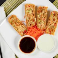 Chicken Egg Rolls · House made, stuffed with chicken, red bell peppers, scallions and cabbage, served with wasab...