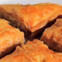 Baklava · Layered phyllo pastry filled with crushed walnuts, cinnamon & honey syrup.