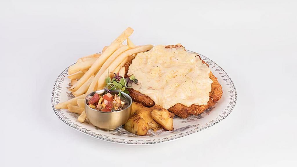 Chic Chicken Chic · Our version of the 90s Argentinian classic, Milanesa Maryland. Crunchy breaded chicken breast covered with an extra creamy “humita” sauce + a side of crispy french fries & maduros.