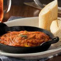 Huevos Rancheros · Delicious fresh Eggs cooked in our Homemade Tomato, Red & Green Bell Pepper sauce.