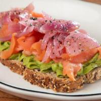 Salmon Avocado Toast · Multigrain Toasted Bread, Avocado spread, Smoked Salmon, Sautéed Red Onions & Caper Mix, Bla...