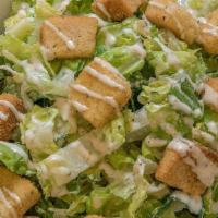 Caesar Salad · Romaine Lettuce, Caesar dressing, Herb Croutons & Parmesan Cheese.