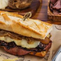 French Dip Sandwich · Slow cooked Roast Beef, melted Swiss Cheese & Caramelized Onions with a salty 