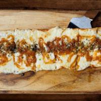 Flatbread Caramelized Onion · Thin-crust bread topped with mozzarella, Parmigiano, caramelized onions, oregano, and olive ...