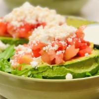 Avocado Salad · Two half avocado stuffed with tomatoes, feta cheese over a bed of greens with a homemade dre...