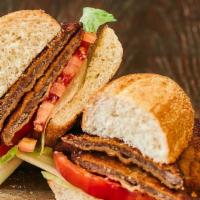 Milanesa Sandwich · Veal or chicken milanese with lettuce and tomato.