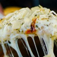 Stuffed Fugazzeta · Mozzarella, onions, oregano, parmigiano cheese, stuffed with mozzarella and cooked ham, and ...