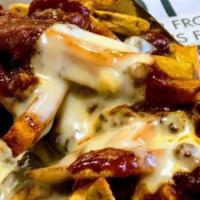 Chili Cheese Fries · Fresh cut daily, double blanched and topped with chili and queso.