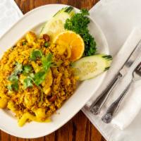 Pineapple Fried Rice · Stir-fried jasmine rice with pineapple, egg, carrots, peas, yellow curry powder, raisins, ca...