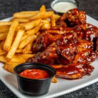 Wings · Comes tossed in your choice of sauce and served with a side of our famous house fries.
