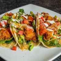 Chicken Tender Tacos · Chicken tenders breaded served on a flour tortilla with Cheddar cheese, bacon, tomato, lettu...