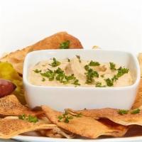 Hummus · Puree of chick peas, tahini, cumin, and lemon juice. Served with soft or baked pita chips.