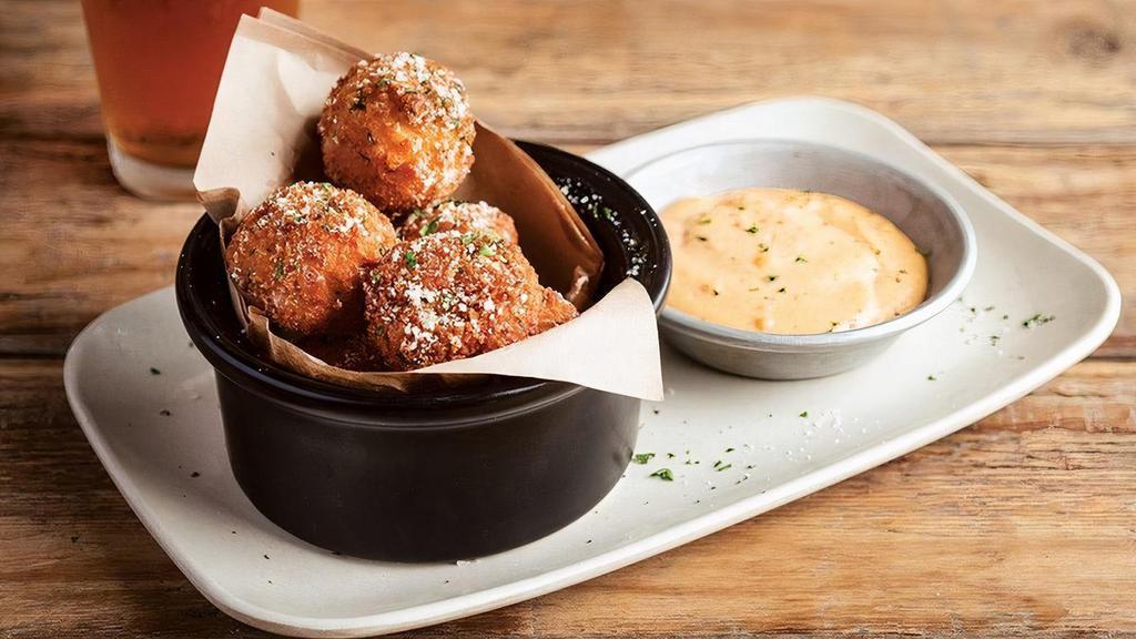 Mac & Cheese Bites · Award-winning bites made in our kitchen daily! Our spicy pepper jack Mac & Cheese hand rolled in herbed panko bread crumbs & fried crispy. Dip them in our Sriracha-Lime Aioli.