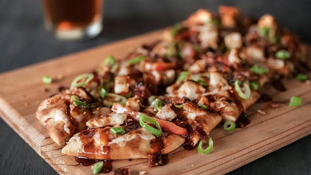 Chipotle Bbq Chicken Flatbread · Tender, grilled chicken with onions, peppers & bacon smothered in mozzarella cheese. Finished with a drizzle of chipotle BBQ.