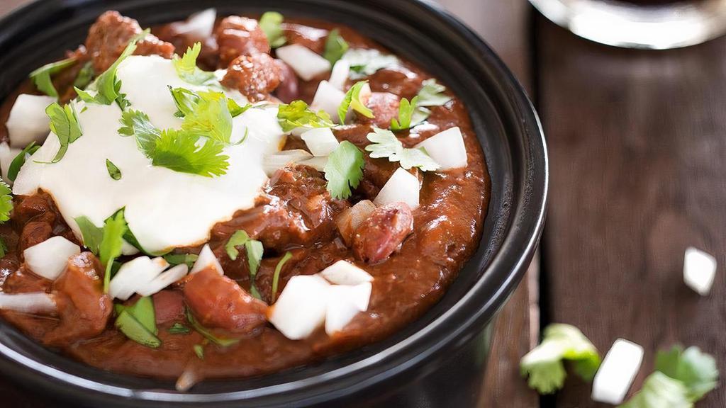 Signature Chili · Our rich & savory steak, chorizo & red bean chili is spiced up with roasted red chilies. Served with sour cream, onions & cilantro on the side to mix in & make it your own.