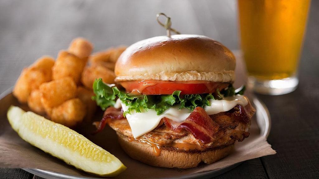 Chipotle Chicken Sandwich · Grilled White Wheat beer-brined chicken breast with applewood smoked bacon, lettuce, tomato, Swiss cheese & chipotle sauce, served on a toasty brioche bun.