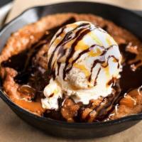 Salted Caramel Cookie Skillet · Fresh out of the oven salted caramel almond cookie, topped with vanilla bean ice cream and d...