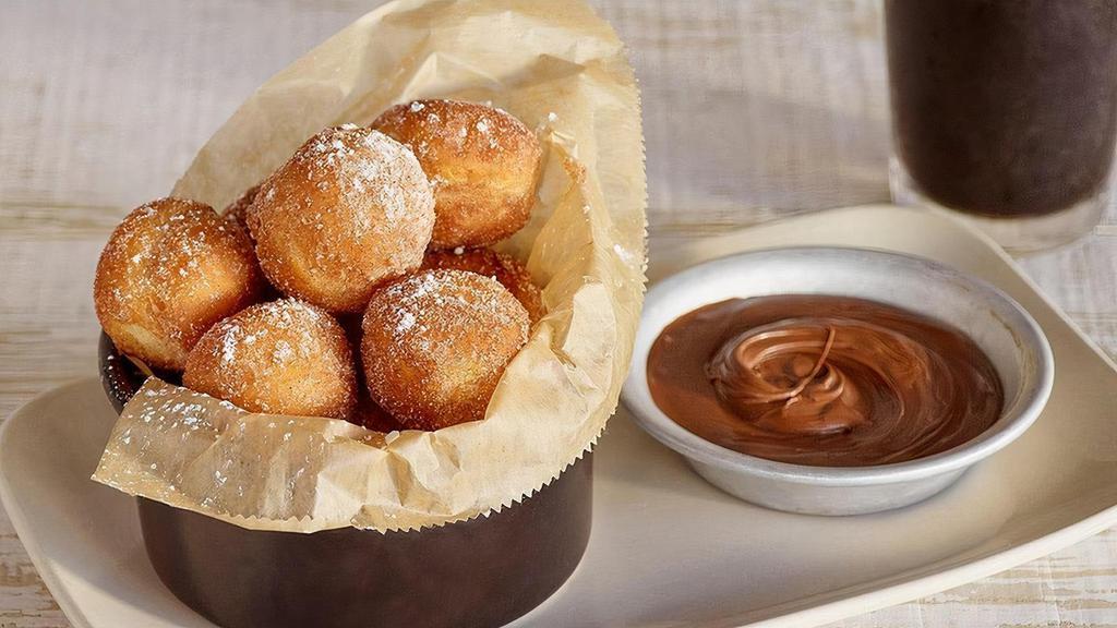 Nutella® “Churro” Donuts · Fresh fried donuts tossed in cinnamon sugar & served with a side of NUTELLA®.