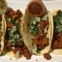Tacos Al Pastor · Are made from thin strips of pork that have been marinated in spices and chiles and then sta...